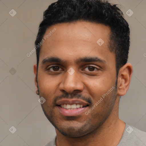 Joyful black young-adult male with short  black hair and brown eyes