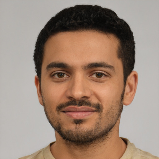 Joyful latino young-adult male with short  black hair and brown eyes
