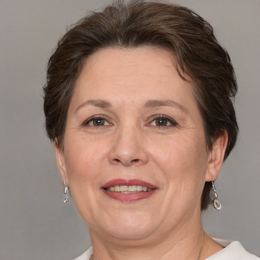 Joyful white adult female with medium  brown hair and grey eyes