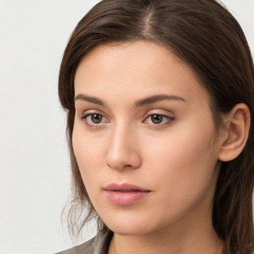 Neutral white young-adult female with long  brown hair and brown eyes