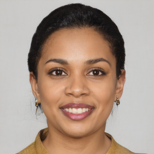 Joyful latino young-adult female with short  black hair and brown eyes