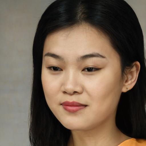 Joyful asian young-adult female with long  brown hair and brown eyes