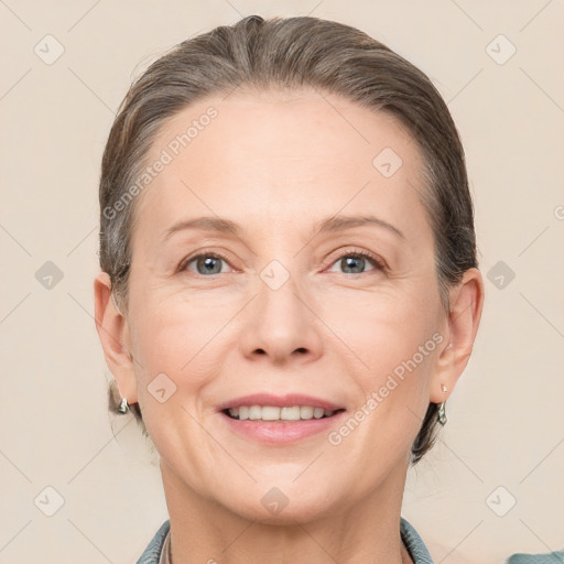 Joyful white adult female with medium  brown hair and grey eyes