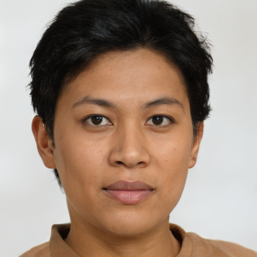 Joyful asian young-adult female with short  brown hair and brown eyes