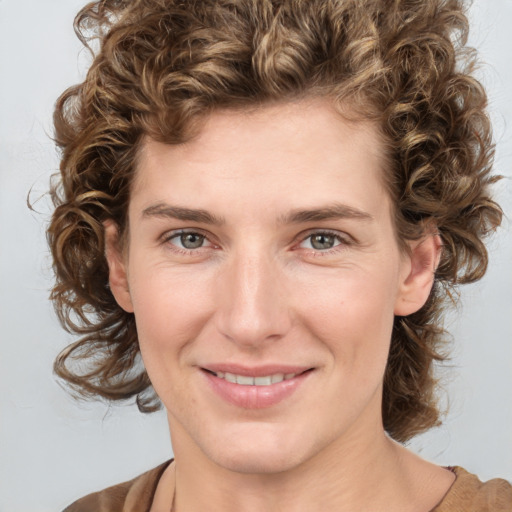 Joyful white young-adult female with medium  brown hair and blue eyes