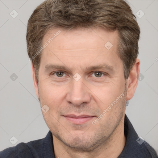 Joyful white adult male with short  brown hair and grey eyes