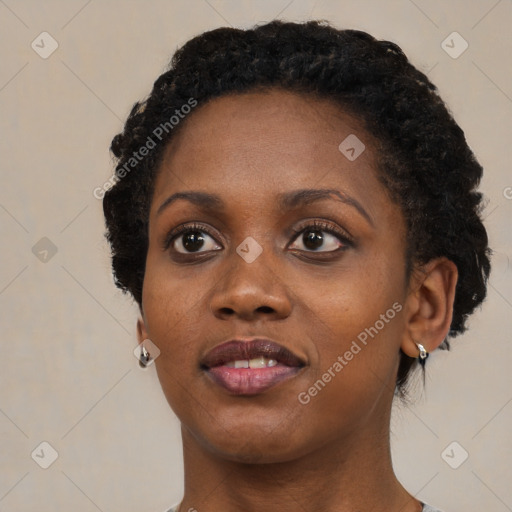 Joyful black young-adult female with short  black hair and brown eyes