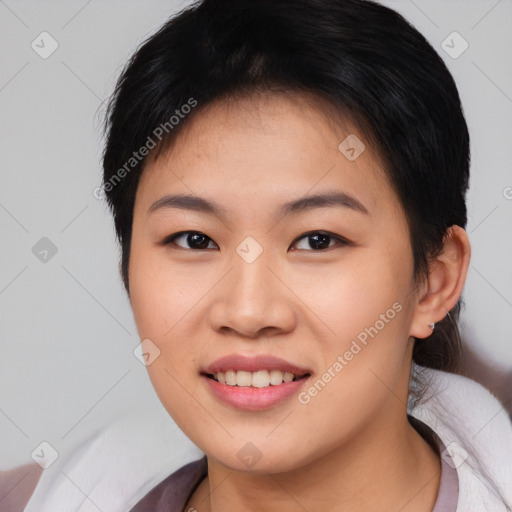 Joyful asian young-adult female with short  brown hair and brown eyes