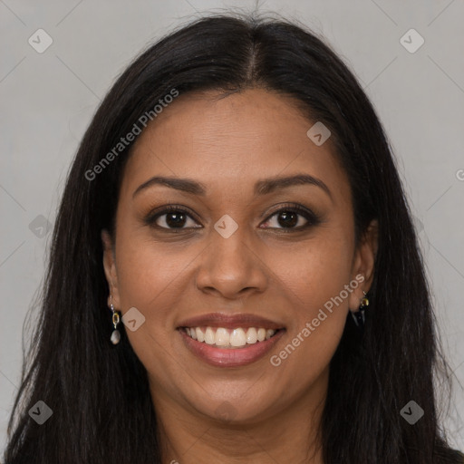 Joyful black young-adult female with long  brown hair and brown eyes