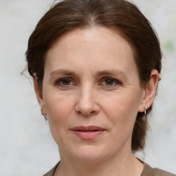 Joyful white adult female with medium  brown hair and grey eyes