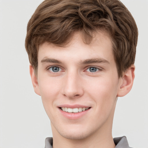 Joyful white child male with short  brown hair and grey eyes