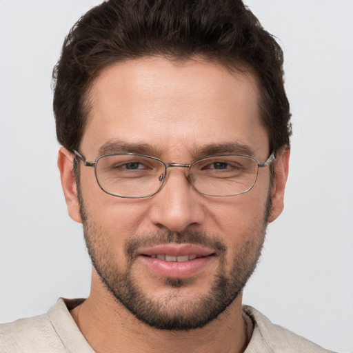 Joyful white young-adult male with short  brown hair and grey eyes