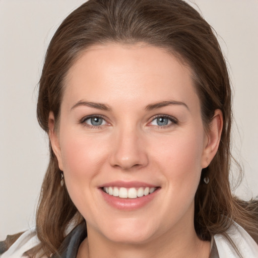 Joyful white young-adult female with medium  brown hair and grey eyes