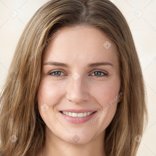 Joyful white young-adult female with long  brown hair and green eyes