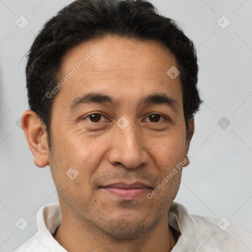 Joyful latino adult male with short  brown hair and brown eyes