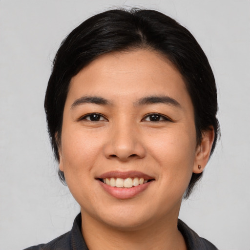 Joyful asian young-adult female with medium  black hair and brown eyes