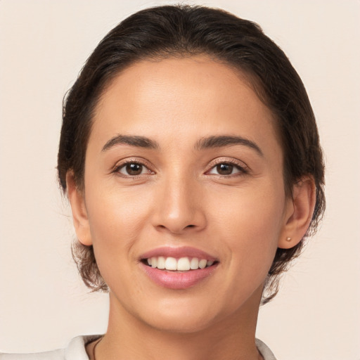 Joyful white young-adult female with medium  brown hair and brown eyes