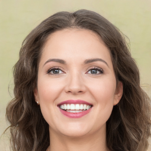 Joyful white young-adult female with medium  brown hair and green eyes