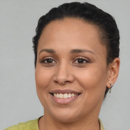 Joyful black young-adult female with short  brown hair and brown eyes