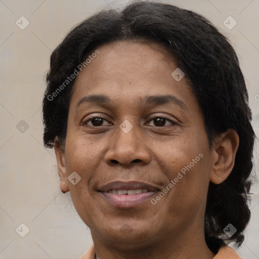 Joyful black adult female with medium  brown hair and brown eyes