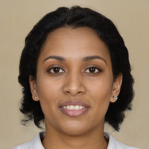 Joyful black young-adult female with medium  black hair and brown eyes