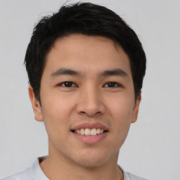 Joyful asian young-adult male with short  black hair and brown eyes