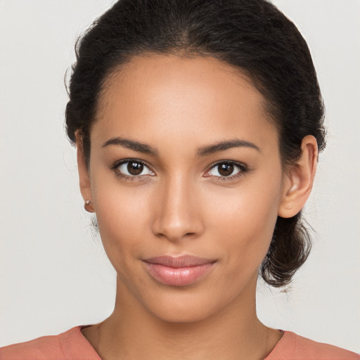 Joyful latino young-adult female with medium  brown hair and brown eyes