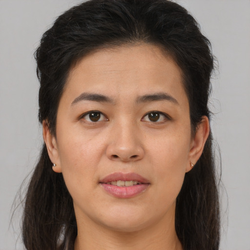 Joyful white young-adult female with long  brown hair and brown eyes