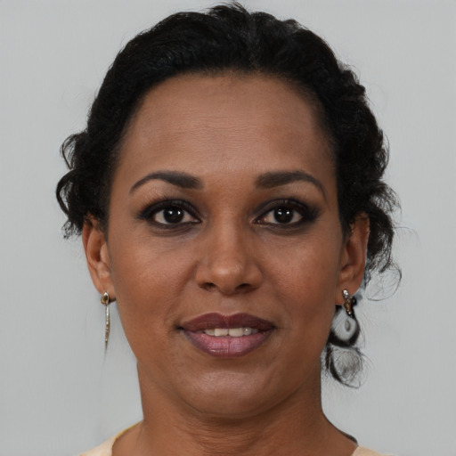 Joyful black adult female with short  brown hair and brown eyes