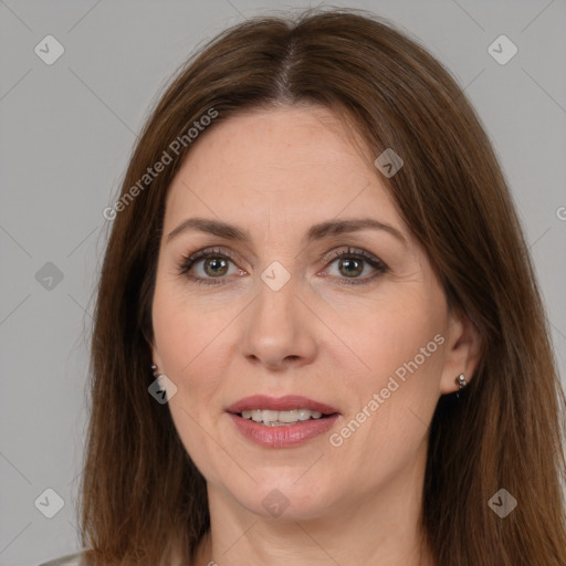 Joyful white adult female with long  brown hair and brown eyes