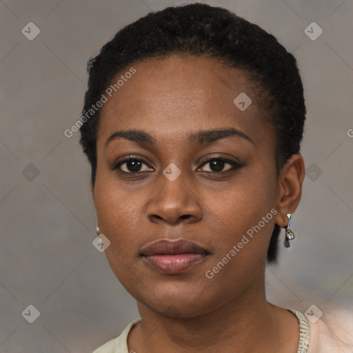 Joyful black young-adult female with short  black hair and brown eyes