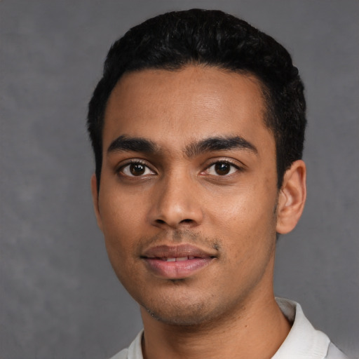 Joyful latino young-adult male with short  black hair and brown eyes