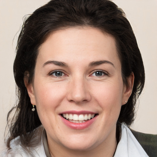 Joyful white adult female with medium  brown hair and brown eyes