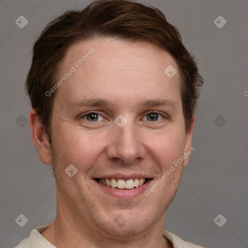 Joyful white adult male with short  brown hair and grey eyes