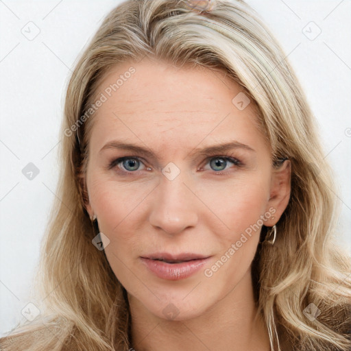 Joyful white young-adult female with long  brown hair and blue eyes