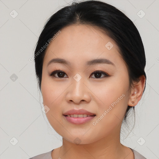 Joyful asian young-adult female with medium  black hair and brown eyes