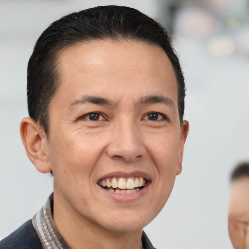 Joyful white adult male with short  brown hair and brown eyes