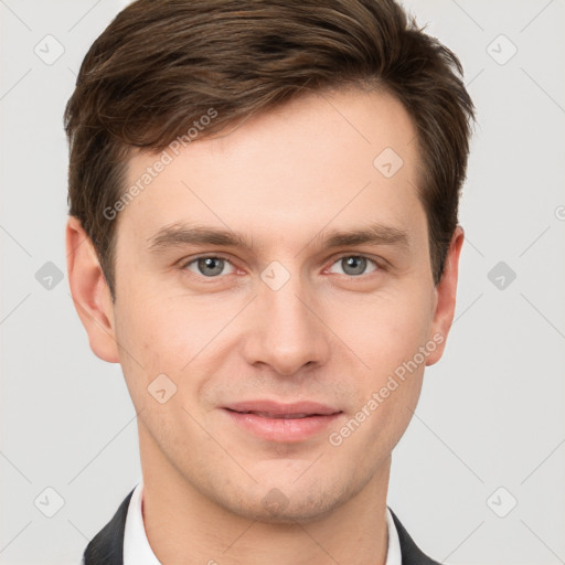 Joyful white young-adult male with short  brown hair and grey eyes