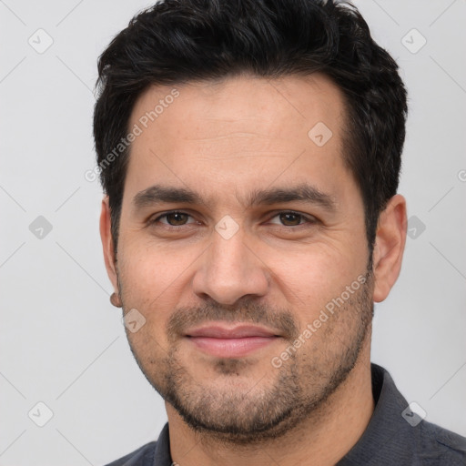 Joyful white young-adult male with short  black hair and brown eyes