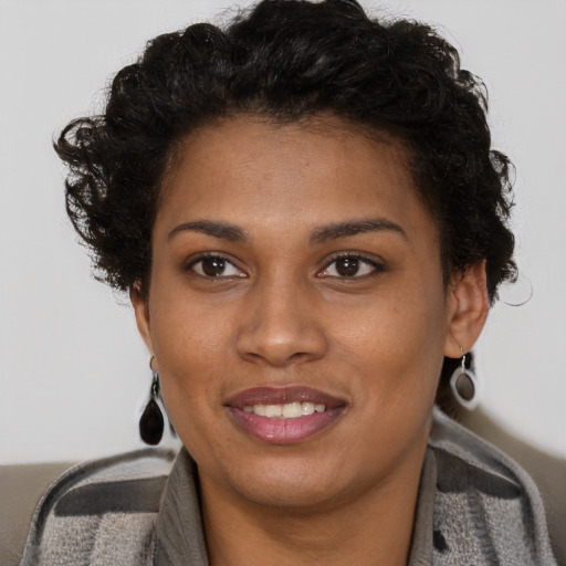 Joyful black young-adult female with short  brown hair and brown eyes