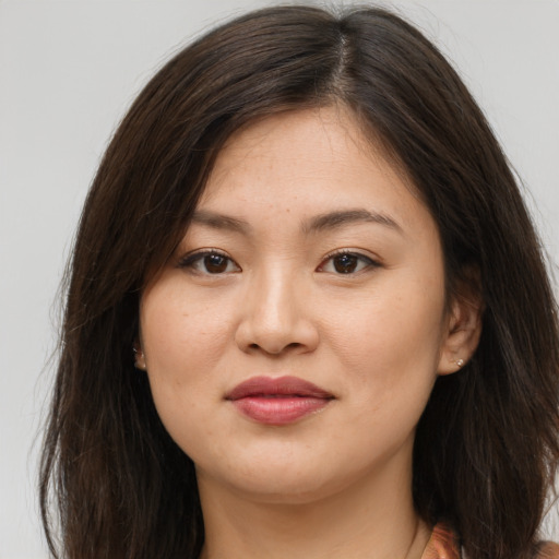 Joyful asian young-adult female with long  brown hair and brown eyes