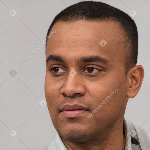 Joyful black young-adult male with short  black hair and brown eyes