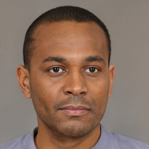 Neutral black adult male with short  brown hair and brown eyes
