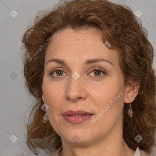 Joyful white adult female with medium  brown hair and green eyes