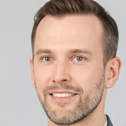 Joyful white adult male with short  brown hair and brown eyes