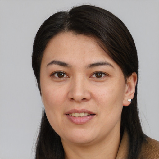 Joyful asian young-adult female with long  brown hair and brown eyes