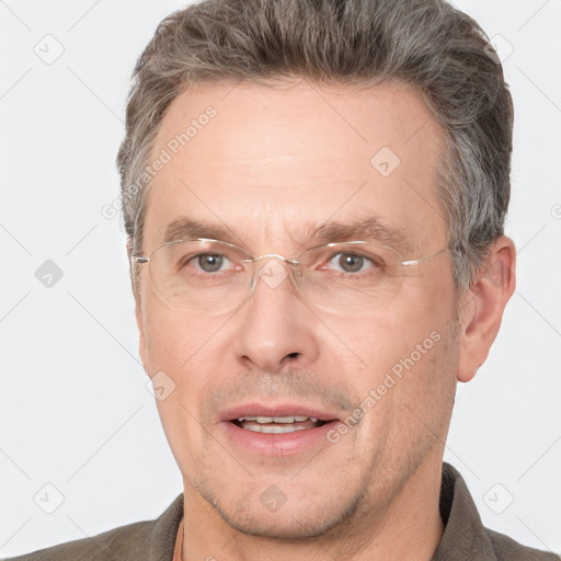 Joyful white adult male with short  brown hair and grey eyes