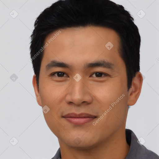 Joyful asian young-adult male with short  black hair and brown eyes