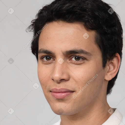 Joyful white young-adult male with short  black hair and brown eyes