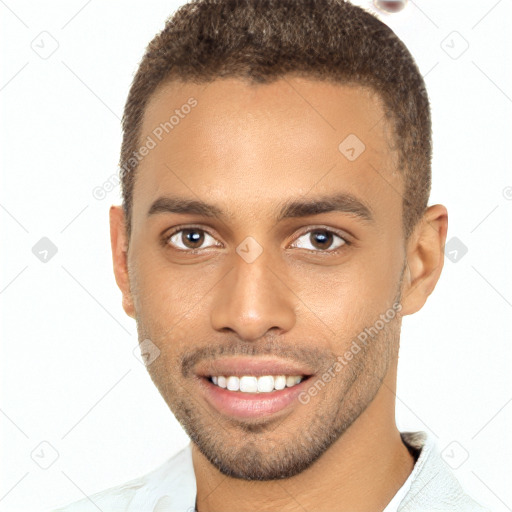 Joyful black young-adult male with short  brown hair and brown eyes